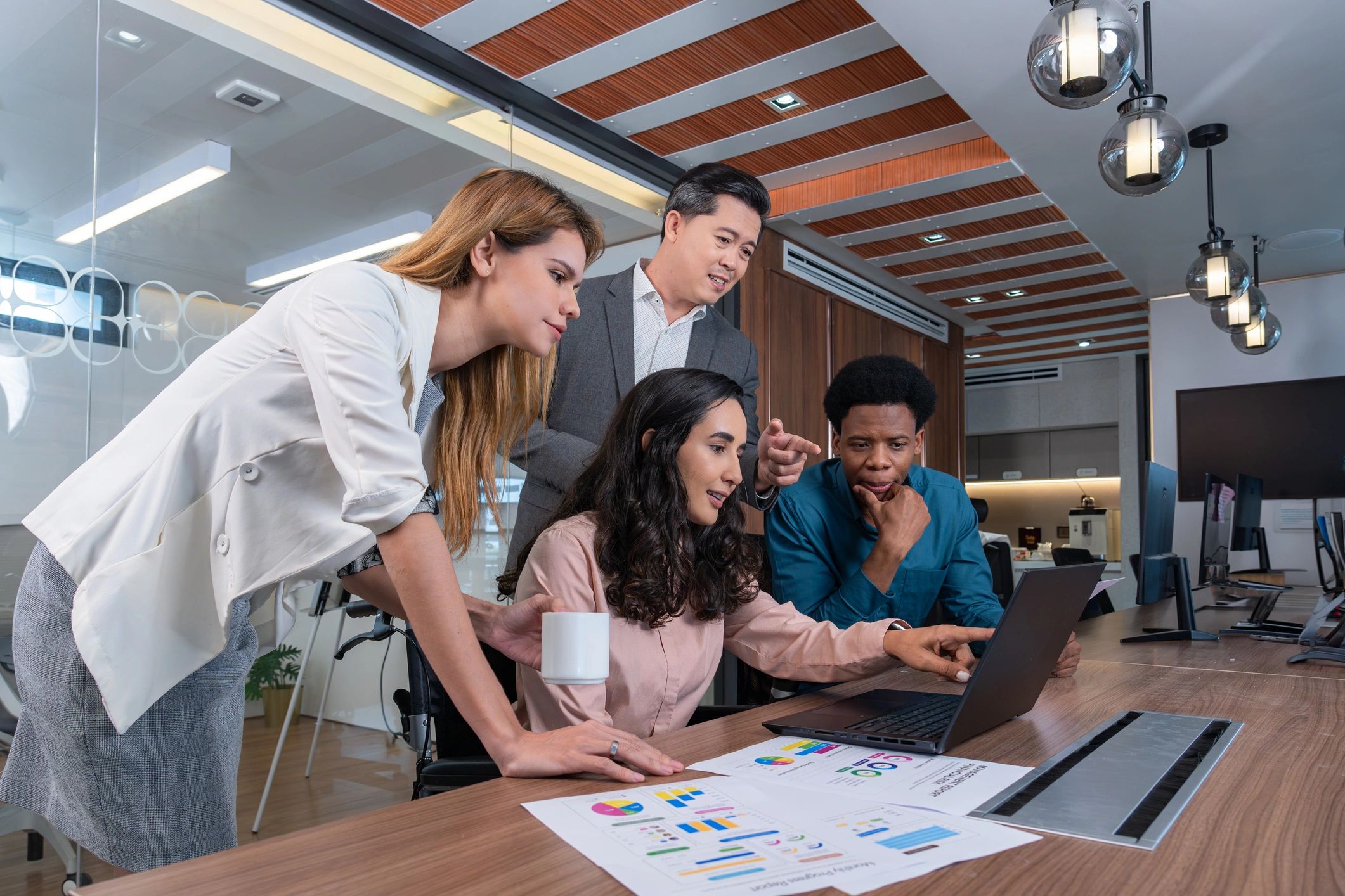 Small group of colleagues collaborating in a modern office meeting room