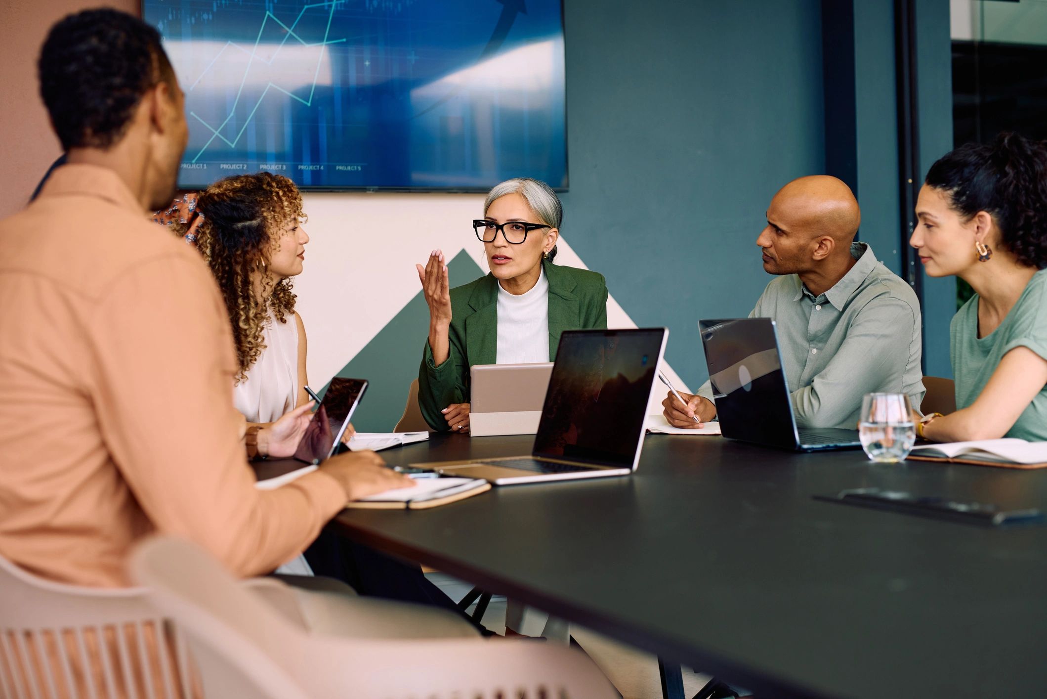 Wide shot of diverse business team collaborating around conference table